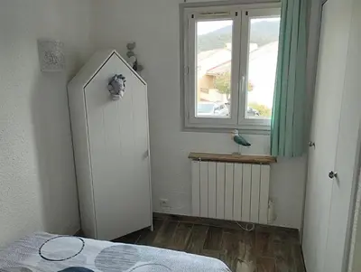 a room with a white refrigerator and a window at Appartement T2 Porticcio Vue sur Mer in Porticcio