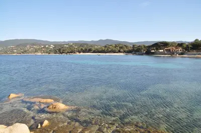 a large body of water with a beach in the background at Appartement T2 Porticcio Vue sur Mer in Porticcio