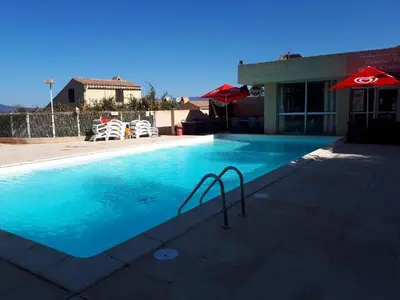 a large swimming pool with aicrobialicrobialicrobialicrobial at Appartement T2 Porticcio Vue sur Mer in Porticcio