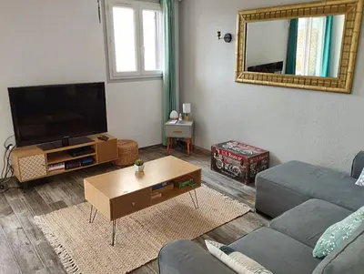 a living room with a couch and a tv at Appartement T2 Porticcio Vue sur Mer in Porticcio