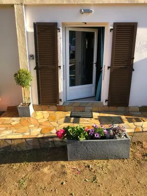 a front door of a house with some flowers at Charmant appartement à Ajaccio in Ajaccio