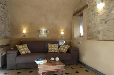a living room with a couch and a table at Au coeur du Village de Lucciana in Lucciana