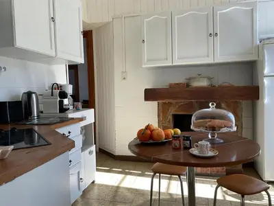 a kitchen with a table with fruit on it at Au coeur du Village de Lucciana in Lucciana