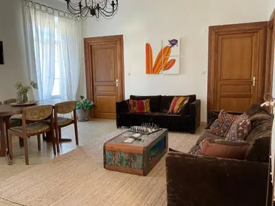 a living room with a couch and a table at Au coeur du Village de Lucciana in Lucciana