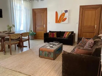 a living room with a couch and a table at Au coeur du Village de Lucciana in Lucciana