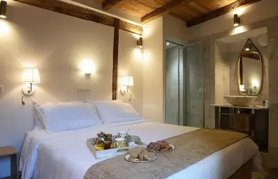 a bedroom with a bed with a tray of food on it at Au coeur du Village de Lucciana in Lucciana