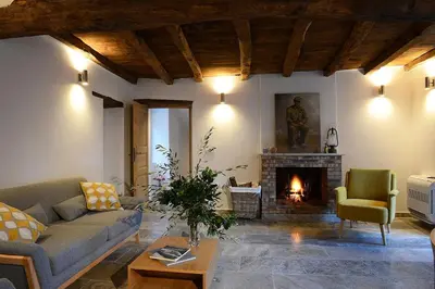 a living room with a couch and a fireplace at Au coeur du Village de Lucciana in Lucciana