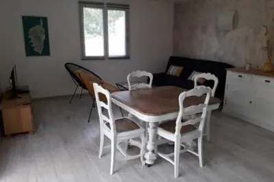 a dining table and chairs in a living room at Gites Albareddu Conca in Conca