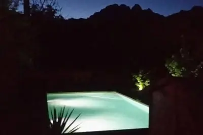 a swimming pool lit up at night at Gites Albareddu Conca in Conca