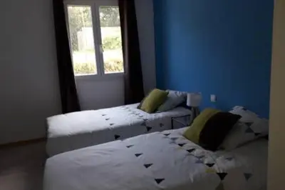 a blue room with two beds and a window at Gites Albareddu Conca in Conca