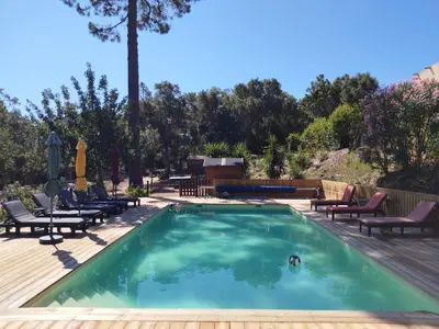 a swimming pool with chaise lounge chairs and a table at Gites Albareddu Conca in Conca