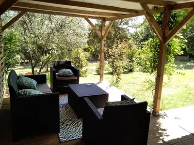 a patio with chairs and a table on a deck at Gites Albareddu Conca in Conca