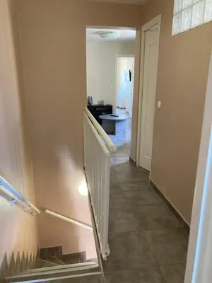 a hallway with a staircase in a house at DUPLEX 4 PERSONNES Clim Wifi Parking in Partinello