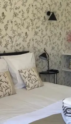 a bed with two pillows and a lamp in a bedroom at DOMAINE NAPOLEON CORSICA FIGARI in Figari