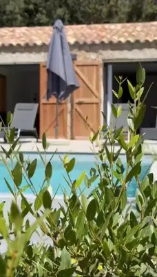 a closed umbrella sitting next to a pool at DOMAINE NAPOLEON CORSICA FIGARI in Figari