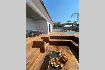 a wooden deck with a bowl of fruit on it at Villa moderne avec Piscine - Porticcio in Grosseto-Prugna