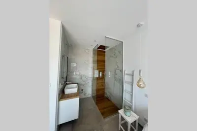 a white bathroom with a shower and a sink at Villa moderne avec Piscine - Porticcio in Grosseto-Prugna