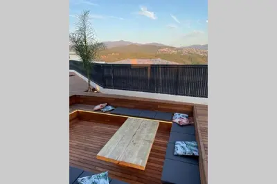 a deck with a bench and a view of the mountains at Villa moderne avec Piscine - Porticcio in Grosseto-Prugna