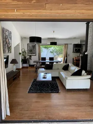 a living room with a white couch and a table at Villa Griseor in Porto-Vecchio