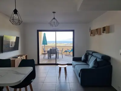 a living room with a couch and a table at LoCorse - Superbe appartement T2 avec une belle vue mer in Grosseto-Prugna