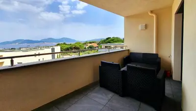 a balcony with two chairs and a view of the ocean at LoCorse - Superbe appartement T2 avec une belle vue mer in Grosseto-Prugna