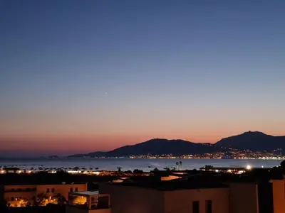 a view of the ocean at night at LoCorse - Superbe appartement T2 avec une belle vue mer in Grosseto-Prugna