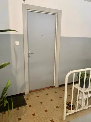 a sliding door in a room with a bed next to it at Joli studio spacieux in Ajaccio
