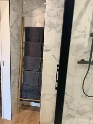 a bathroom with a towel rack and a mirror at Joli studio spacieux in Ajaccio