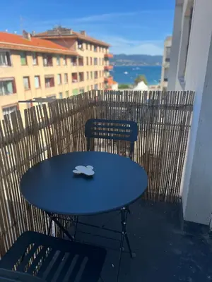 a blue table and two chairs on a balcony at Joli studio spacieux in Ajaccio