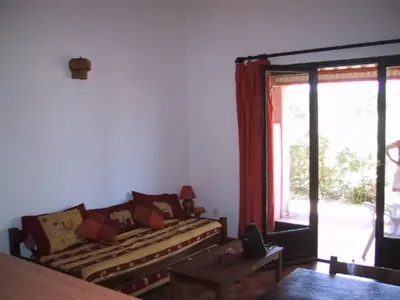 a living room with a couch and a window at Locations A Suara in Porto-Vecchio
