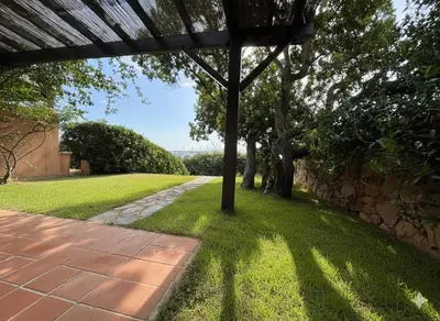 a garden with a pole in the grass at 8 ARBOUSIERS villa 13 in Bonifacio