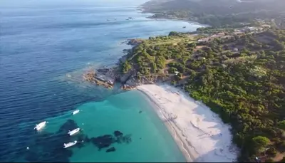 an island in the ocean with boats in the water at 8 ARBOUSIERS villa 13 in Bonifacio