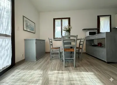 a kitchen and dining room with a table and chairs at 8 ARBOUSIERS villa 13 in Bonifacio