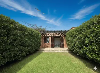 a house with two large hedges in front of it at 8 ARBOUSIERS VILLA 12 in Bonifacio