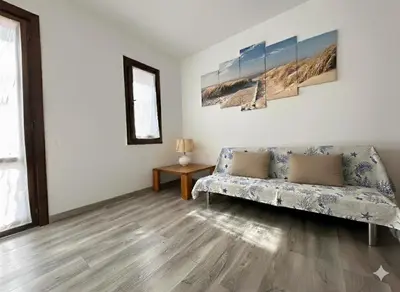 a living room with a couch and a table at 8 ARBOUSIERS VILLA 12 in Bonifacio