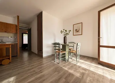 a kitchen and dining room with a glass table and chairs at 8 ARBOUSIERS VILLA 12 in Bonifacio