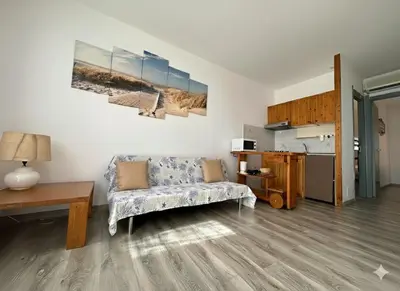 a living room with a couch and a table at 8 ARBOUSIERS VILLA 12 in Bonifacio