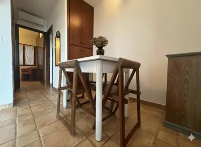 a table and chairs in a room at 8 ARBOUSIERS VILLA 21 in Bonifacio