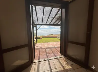 an open door with a view of a yard at 8 ARBOUSIERS VILLA 21 in Bonifacio