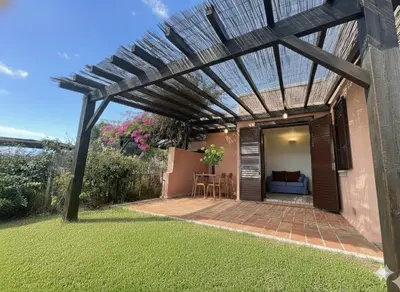 a pergola over a patio in a yard at 8 ARBOUSIERS VILLA 21 in Bonifacio