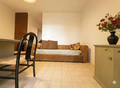 a living room with a couch and a chair at 8 ARBOUSIERS VILLA 19 in Bonifacio