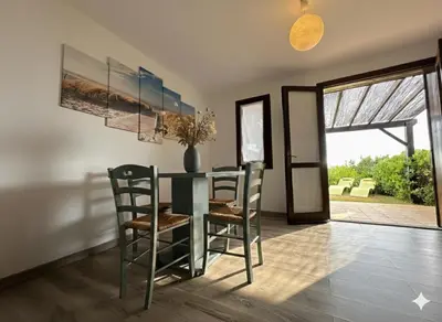 a dining room with a glass table and chairs at 8 ARBOUSIERS VILLA 16 in Bonifacio