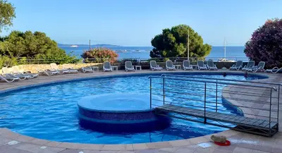 a large swimming pool with lounge chairs and chairs at AJACCIO les iles sanguinaires in Ajaccio