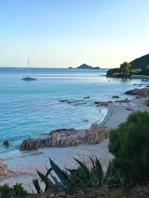 a sail boat in the water on a beach at AJACCIO les iles sanguinaires in Ajaccio