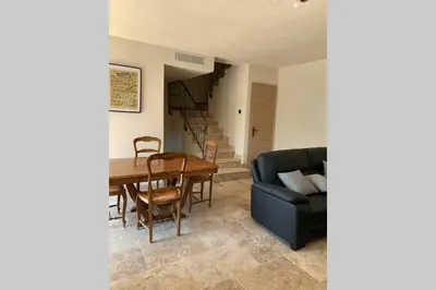a living room with a couch and a table at Maison typique de campagne au cœur de la nature . in Sartène