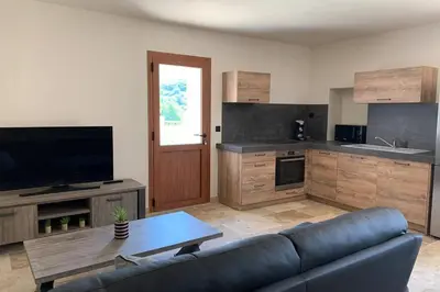 a living room with a couch and a table at Maison typique de campagne au cœur de la nature . in Sartène