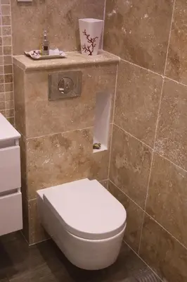a bathroom with a toilet and a tiled wall at AjaccioPanoramicView in Ajaccio