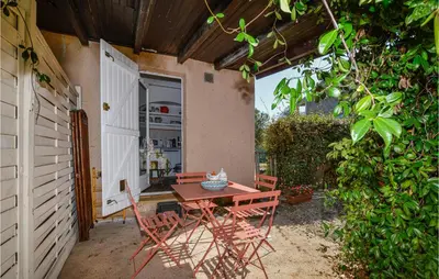 a patio with a table and chairs in a yard at 1 Bedroom Gorgeous Home In Venzolasca in Venzolasca
