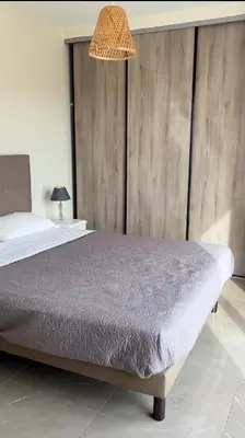 a bedroom with a bed with a wooden wall at Villa Cargese in Cargèse