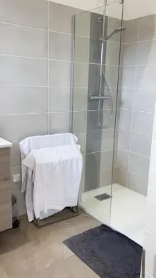 a bathroom with a shower with a towel on a table at Villa Cargese in Cargèse